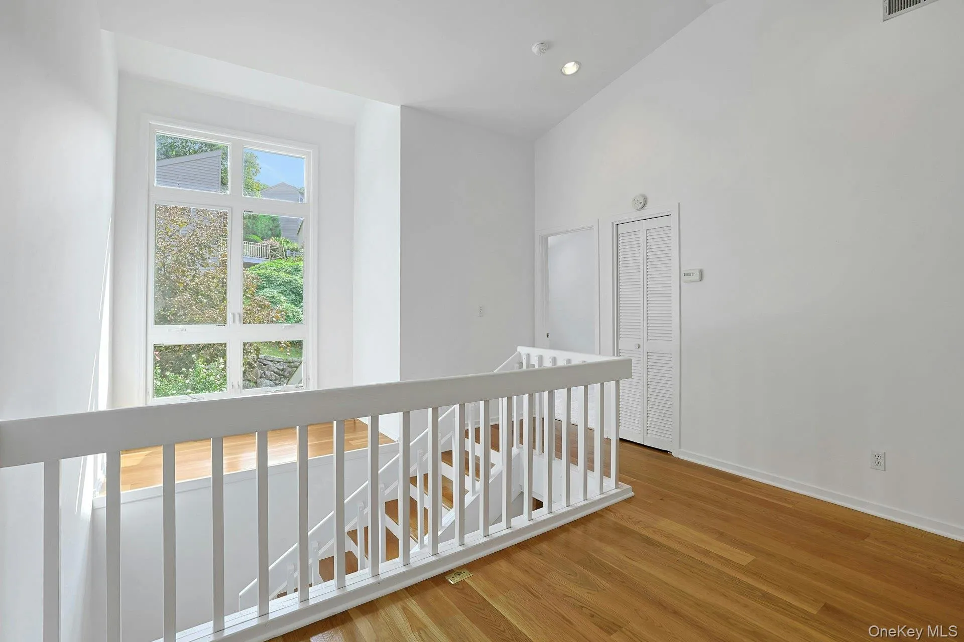 This view of the loft shows the door to the second bedroom as well as the view out to the neighborhood. This view of the loft shows the door to the second bedroom as well as the view out to the neighborhood.