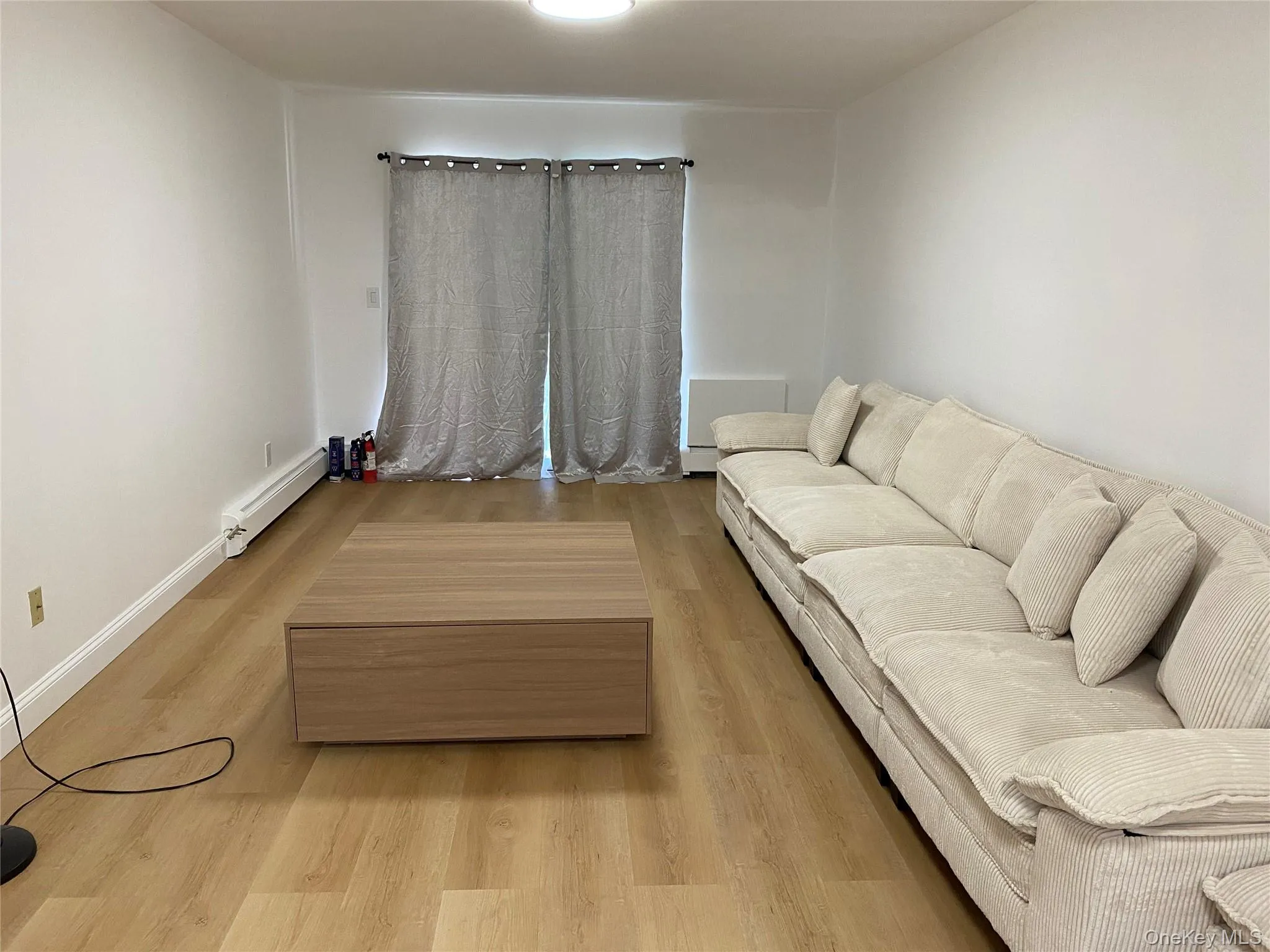 Recessed lighting, wood-finish flooring, and white painted walls Recessed lighting, wood-finish flooring, and white painted walls