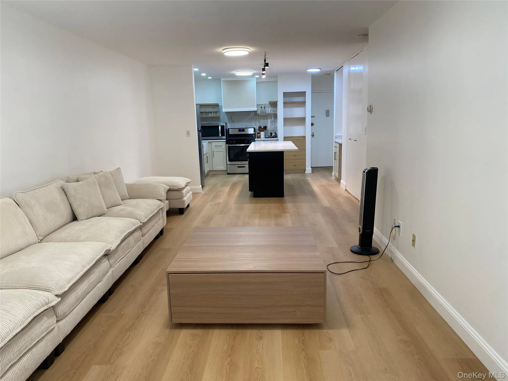 Open-concept living space featuring wood-finish flooring Open-concept living space featuring wood-finish flooring