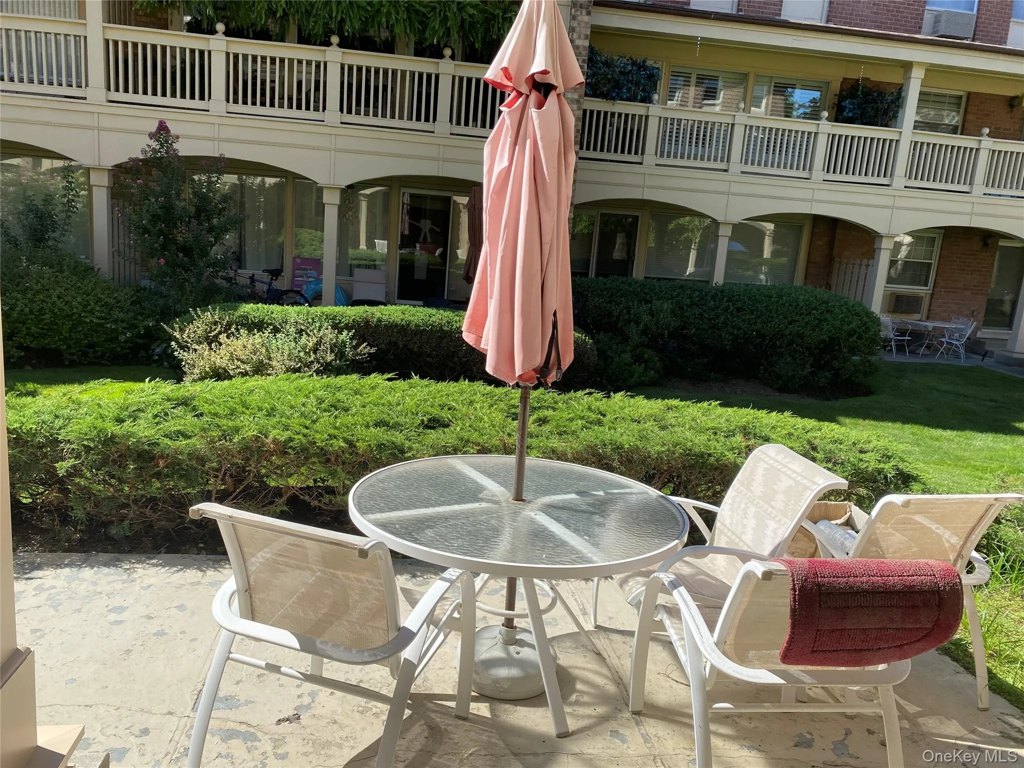 Paved patio area, manicured lawn, and established shrubbery Paved patio area, manicured lawn, and established shrubbery