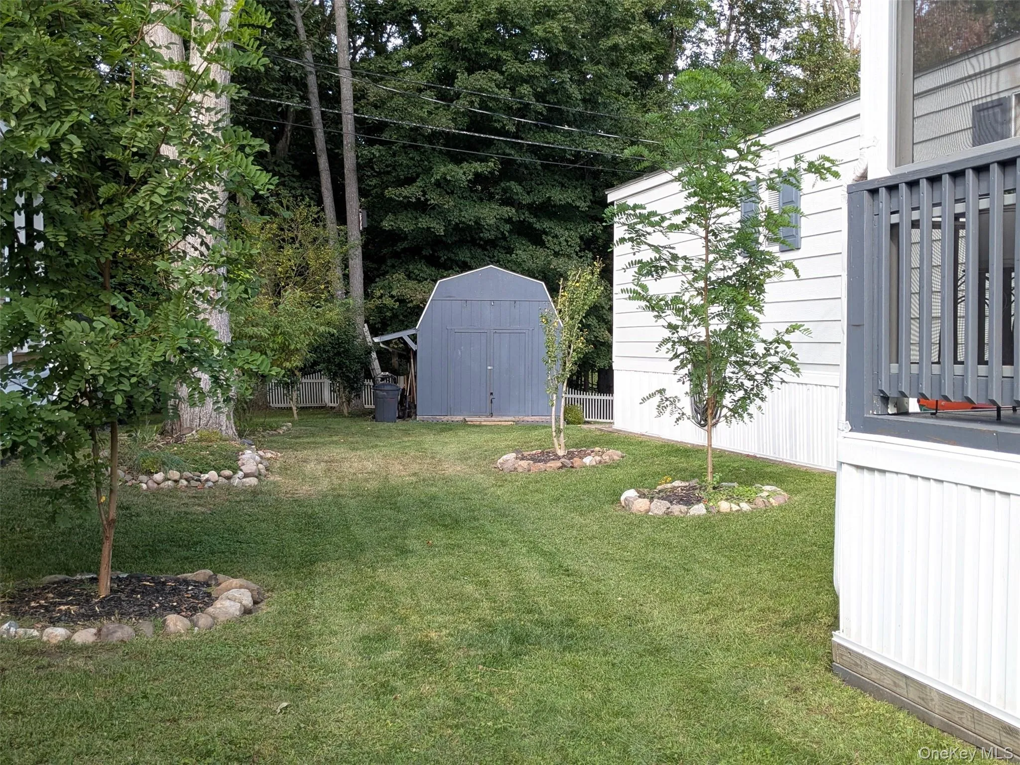 Side yard with deck and shed in back Side yard with deck and shed in back