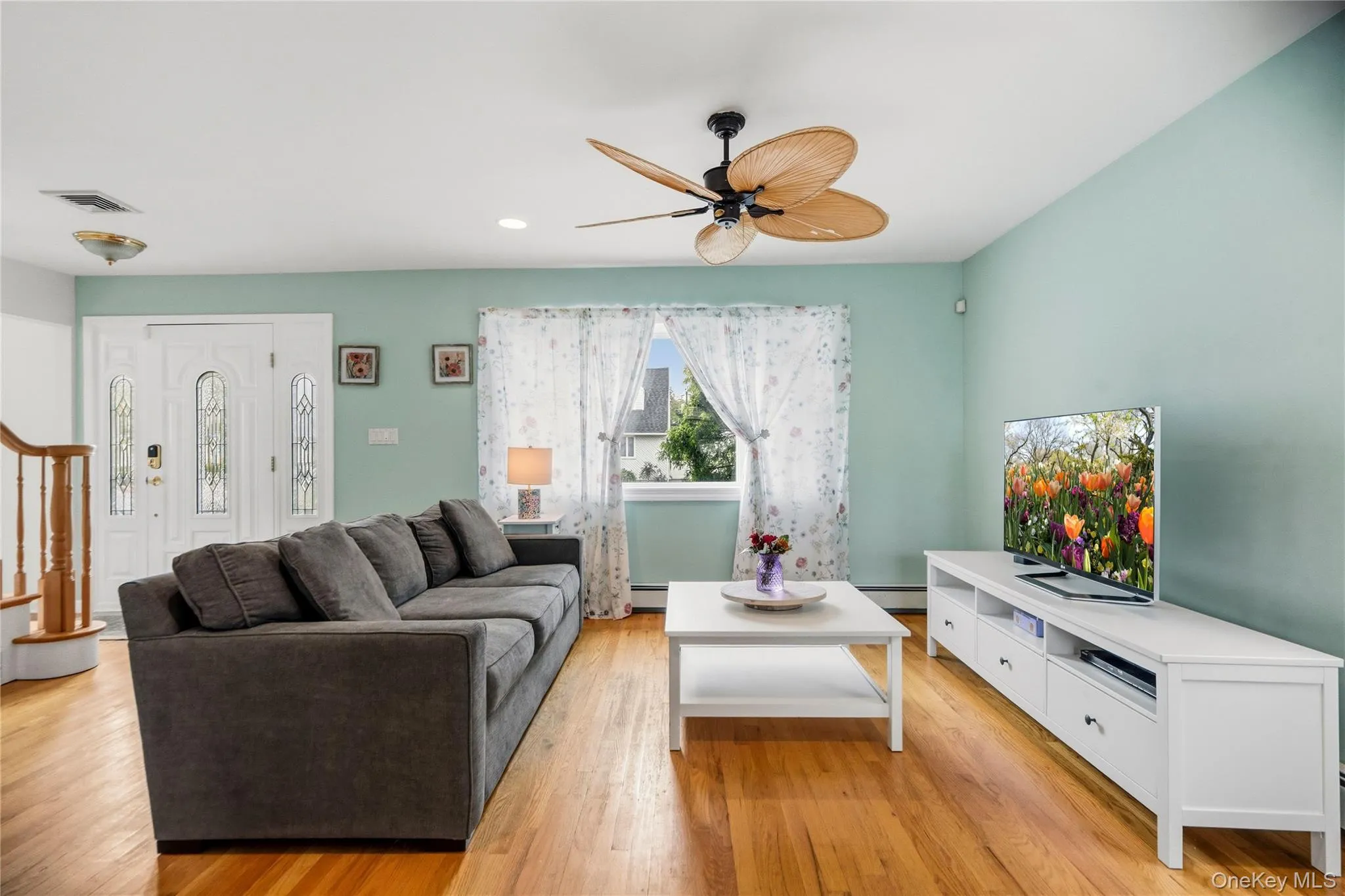 The living room features hardwood floors and a bow window for lots of natural light. The living room features hardwood floors and a bow window for lots of natural light.