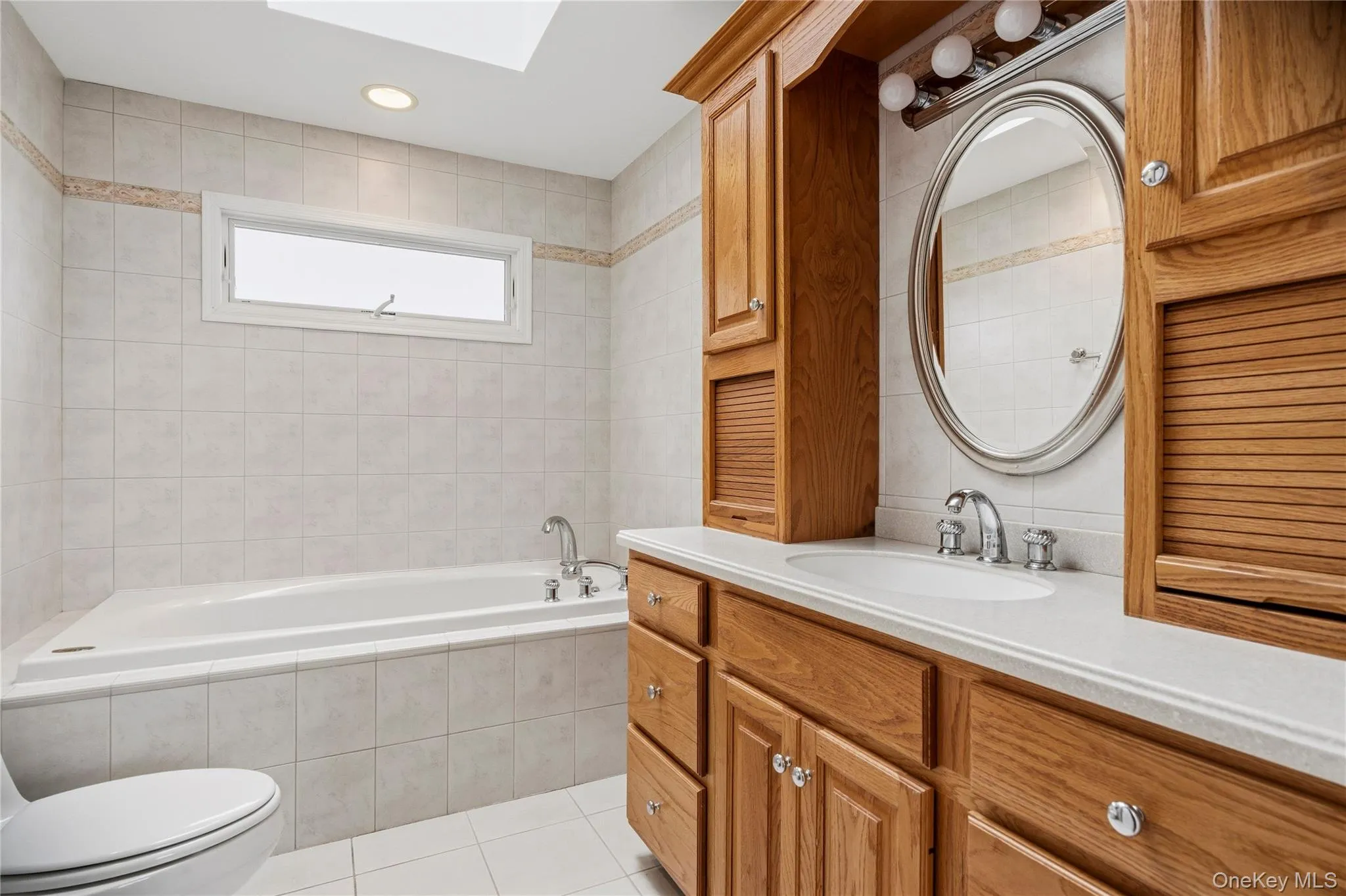 The upper level bathroom provides a custom vanity with plenty of storage, a jetted tub and a stall shower. The upper level bathroom provides a custom vanity with plenty of storage, a jetted tub and a stall shower.