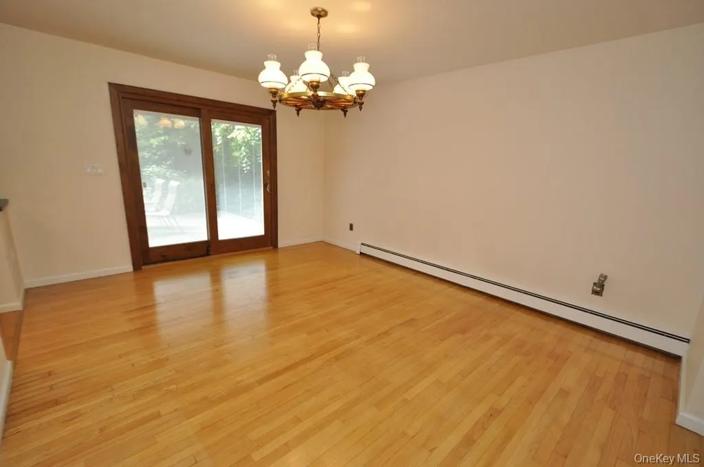 Photo Visually Staged. The Dining Room has hardwood floors, opens to both the Kitchen and Living room and has sliding glass doors to the back patio and yard. The room is approx 15'-7" x 12'-6". Photo Visually Staged. The Dining Room has hardwood floors, opens to both the Kitchen and Living room and has sliding glass doors to the back patio and yard. The room is approx 15'-7" x 12'-6".