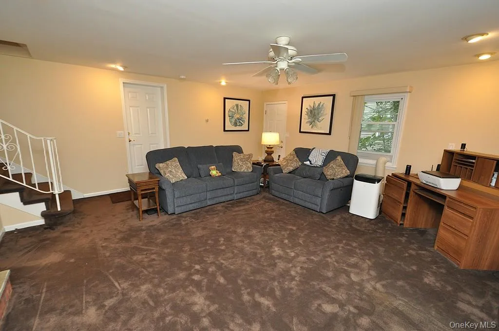 Lower Level recreation room has a fireplace, access to the outside, garage and utility room and storage. The room is approx. 19'-4" x 18'-6". Lower Level recreation room has a fireplace, access to the outside, garage and utility room and storage. The room is approx. 19'-4" x 18'-6".