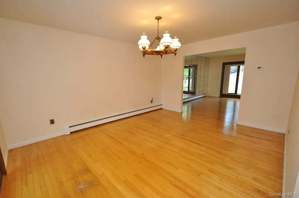 Photo Visually Staged. The Dining Room has hardwood floors, opens to both the Kitchen and Living room and has sliding glass doors to the back patio and yard. The room is approx 15'-7" x 12'-6". Photo Visually Staged. The Dining Room has hardwood floors, opens to both the Kitchen and Living room and has sliding glass doors to the back patio and yard. The room is approx 15'-7" x 12'-6".