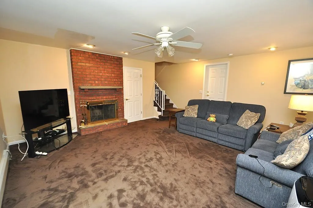 Lower Level recreation room has a fireplace, access to the outside, garage and utility room and storage. The room is approx. 19'-4" x 18'-6". Lower Level recreation room has a fireplace, access to the outside, garage and utility room and storage. The room is approx. 19'-4" x 18'-6".