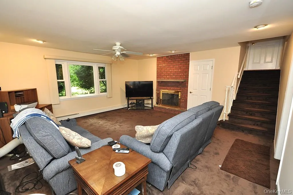 Lower Level recreation room has a fireplace, access to the outside, garage and utility room and storage. The room is approx. 19'-4" x 18'-6". Lower Level recreation room has a fireplace, access to the outside, garage and utility room and storage. The room is approx. 19'-4" x 18'-6".