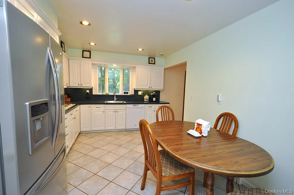 Updated Eat-in-kitchen with granite counters, Stainless Steel French Door refrigerator, wall oven, stove top, and microwave. There is a window over the sink for natural light and ability to watch the backyard. Updated Eat-in-kitchen with granite counters, Stainless Steel French Door refrigerator, wall oven, stove top, and microwave. There is a window over the sink for natural light and ability to watch the backyard.