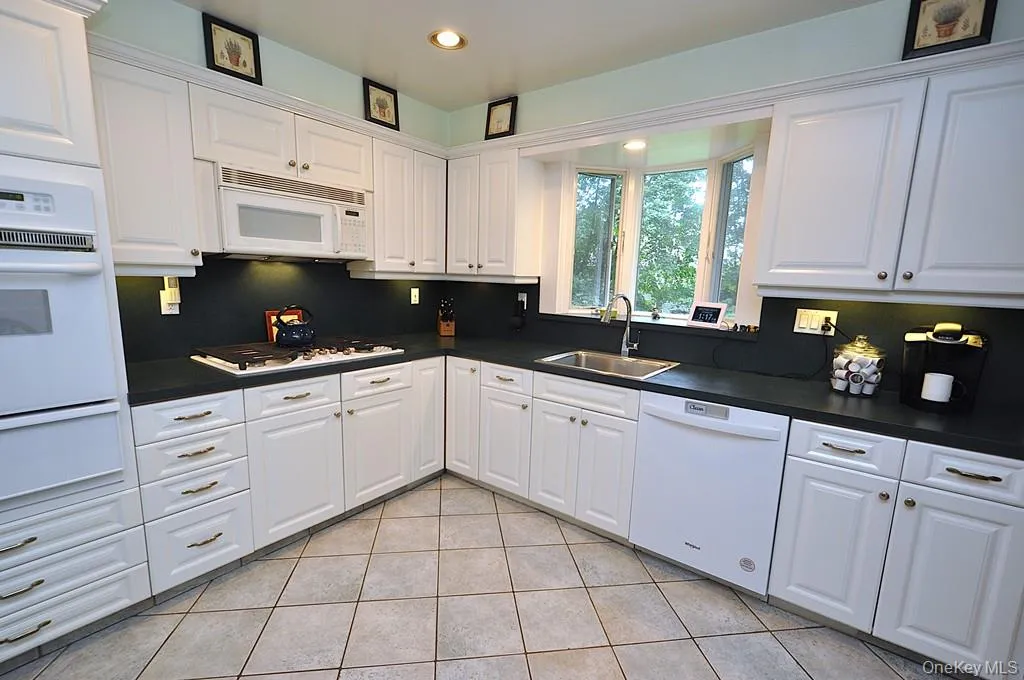 Updated Eat-in-kitchen with granite counters, Stainless Steel French Door refrigerator, wall oven, stove top, and microwave. There is a window over the sink for natural light and ability to watch the backyard. Updated Eat-in-kitchen with granite counters, Stainless Steel French Door refrigerator, wall oven, stove top, and microwave. There is a window over the sink for natural light and ability to watch the backyard.