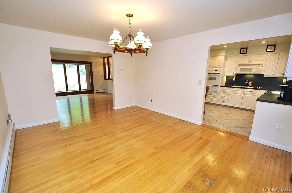 Photo Visually Staged. The Dining Room has hardwood floors, opens to both the Kitchen and Living room and has sliding glass doors to the back patio and yard. The room is approx 15'-7" x 12'-6". Photo Visually Staged. The Dining Room has hardwood floors, opens to both the Kitchen and Living room and has sliding glass doors to the back patio and yard. The room is approx 15'-7" x 12'-6".