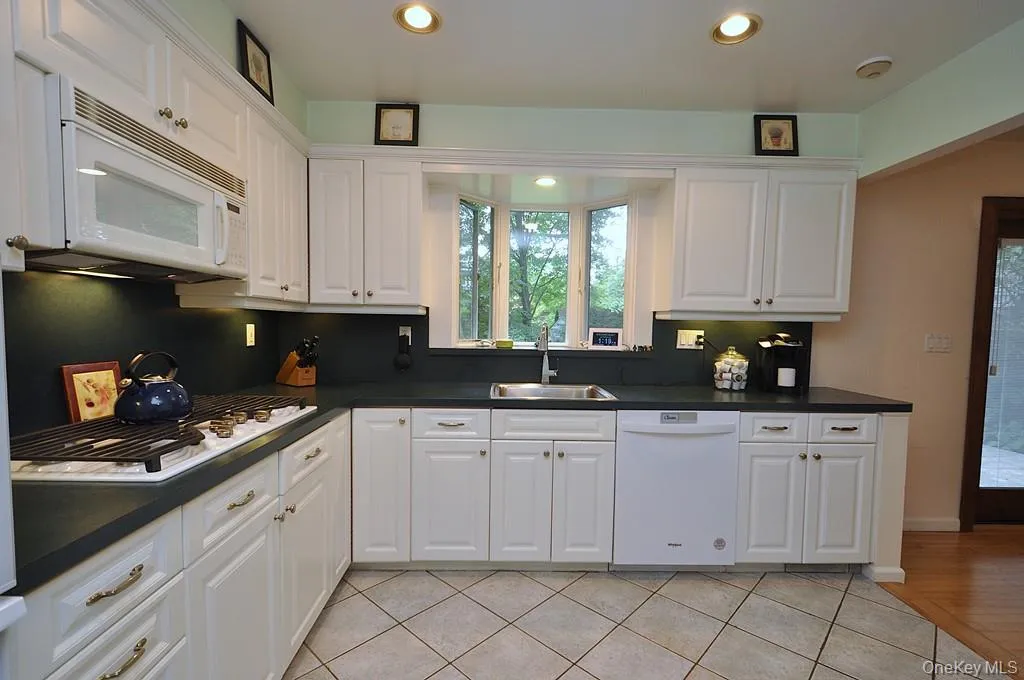Updated Eat-in-kitchen with granite counters, Stainless Steel French Door refrigerator, wall oven, stove top, and microwave. There is a window over the sink for natural light and ability to watch the backyard. Updated Eat-in-kitchen with granite counters, Stainless Steel French Door refrigerator, wall oven, stove top, and microwave. There is a window over the sink for natural light and ability to watch the backyard.