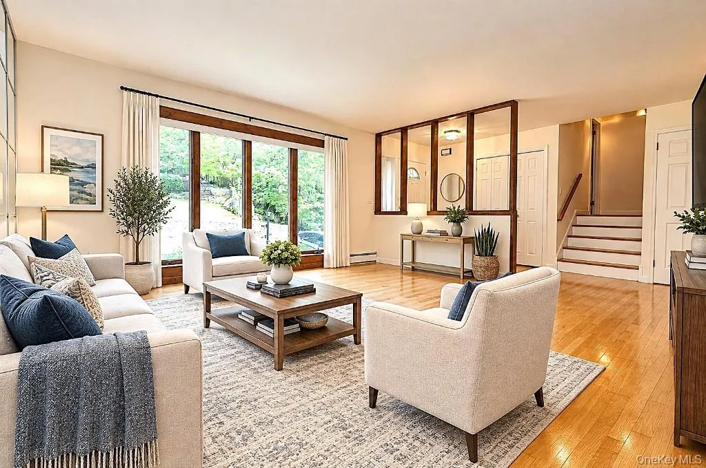 Photo Visually Staged. Living Room has a bay window, hardwood floors and opens to the dining room. Living room is approx 16'-6" x 14'-11" Photo Visually Staged. Living Room has a bay window, hardwood floors and opens to the dining room. Living room is approx 16'-6" x 14'-11"