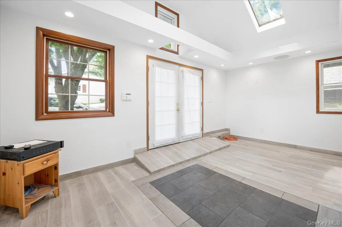 Recessed lighting illuminates ceramic tile flooring throughout the house. Recessed lighting illuminates ceramic tile flooring throughout the house.