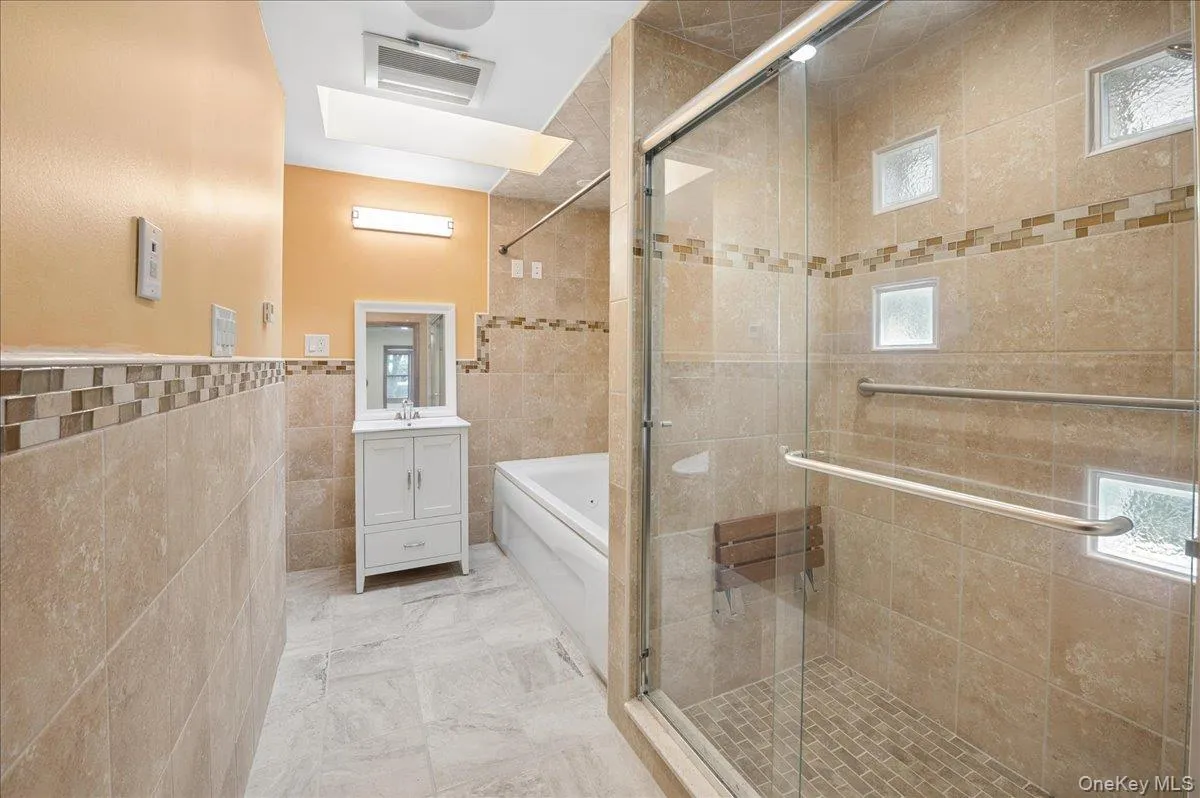 Fully renovated bathroom with jacuzzi tub and shower. Fully renovated bathroom with jacuzzi tub and shower.