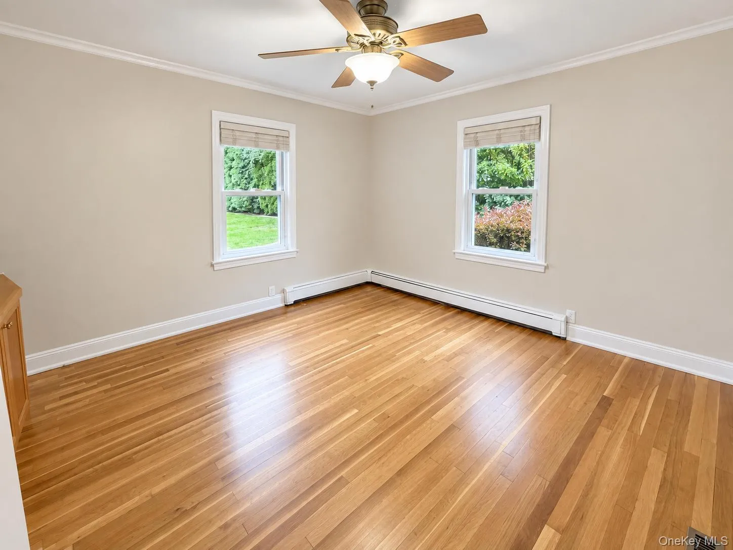 Hardwood flooring, crown molding, two windows with blinds, ceiling fan with light fixture Hardwood flooring, crown molding, two windows with blinds, ceiling fan with light fixture