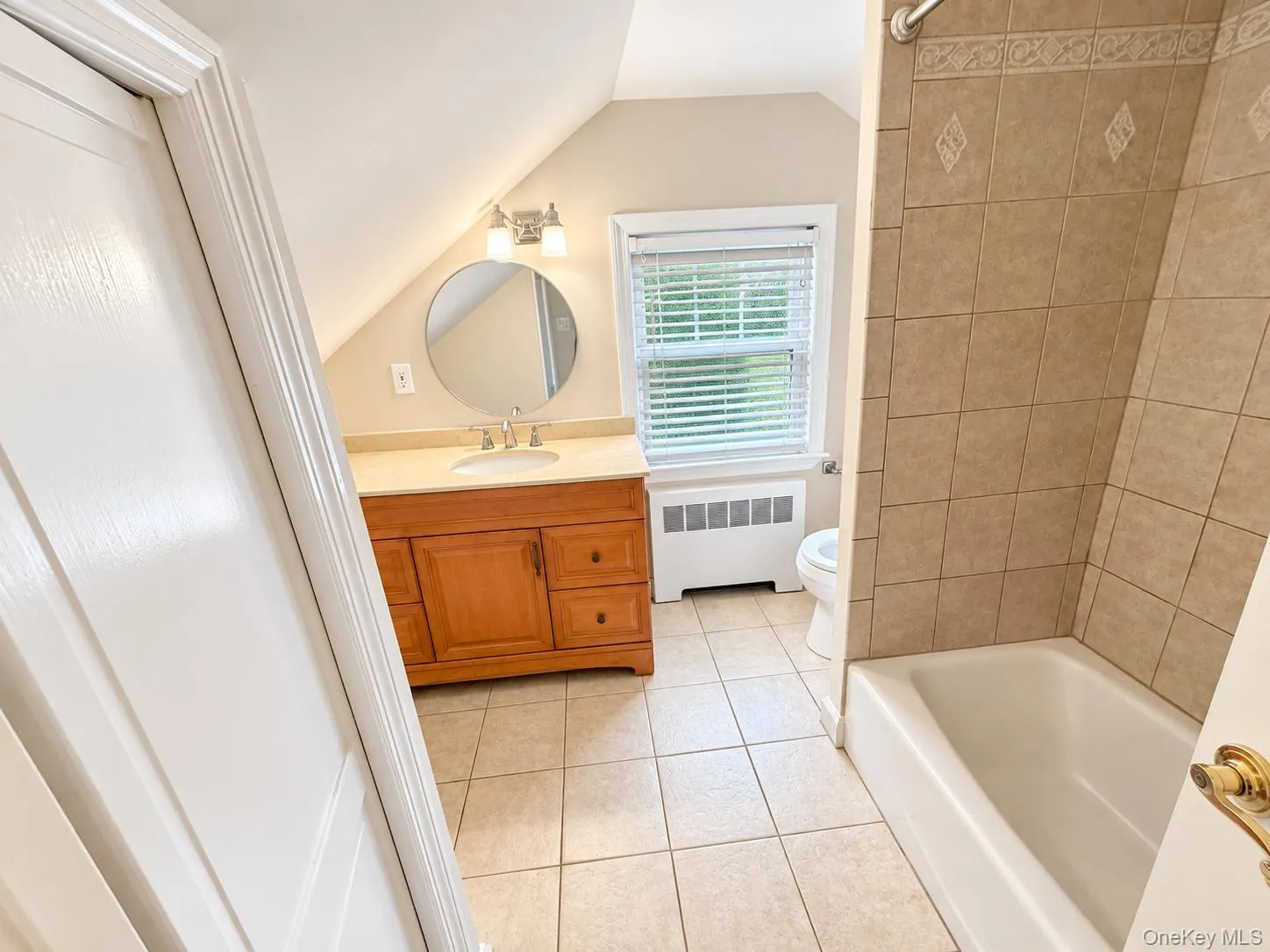 Wood-finish vanity with an integrated sink and light-toned countertop Wood-finish vanity with an integrated sink and light-toned countertop