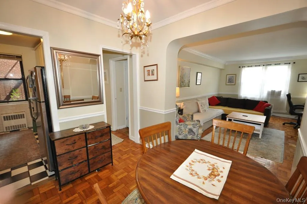 The dining foyer opens to the living room and has a chair rail and parquet floors. The dining foyer opens to the living room and has a chair rail and parquet floors.