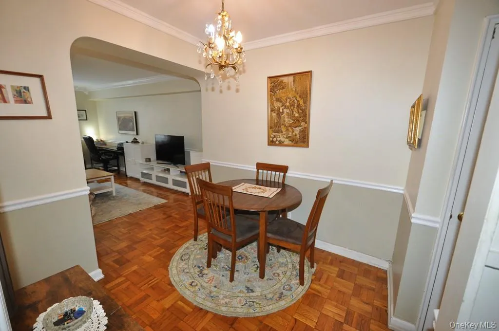 The dining foyer opens to the living room and has a chair rail and parquet floors. The dining foyer opens to the living room and has a chair rail and parquet floors.