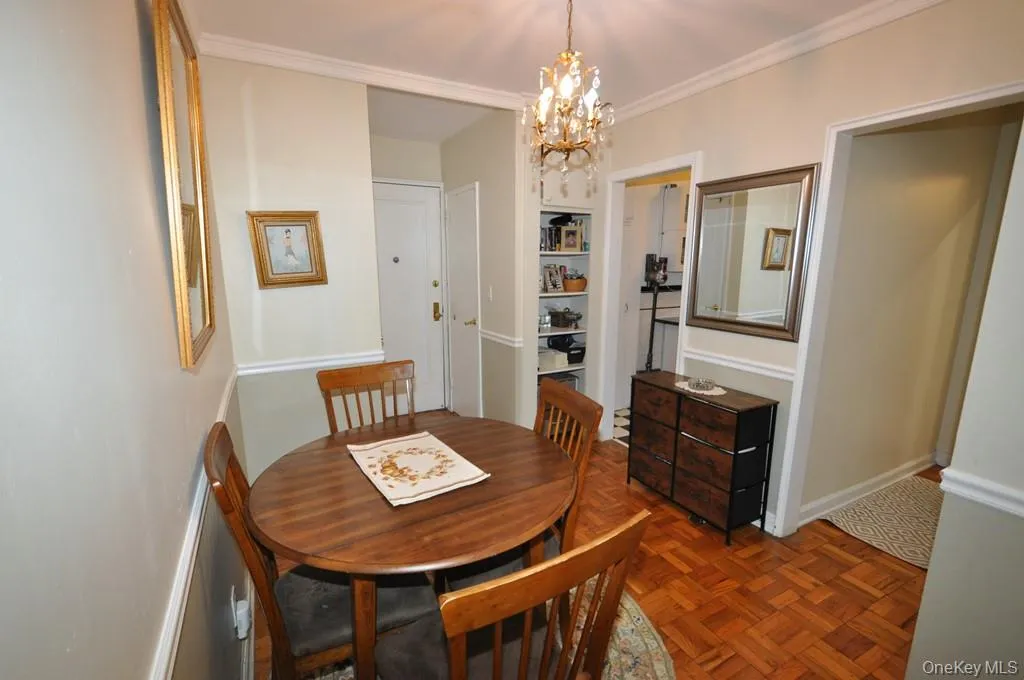 The dining foyer opens to the living room and has a chair rail and parquet floors. The dining foyer opens to the living room and has a chair rail and parquet floors.