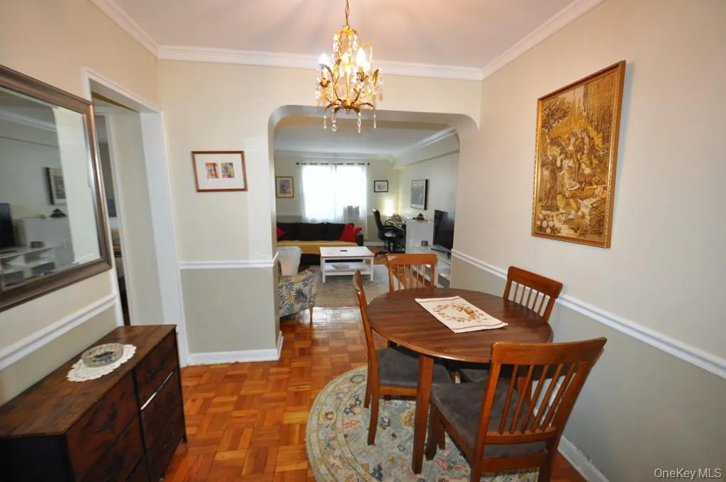 The dining foyer opens to the living room and has a chair rail and parquet floors. The dining foyer opens to the living room and has a chair rail and parquet floors.