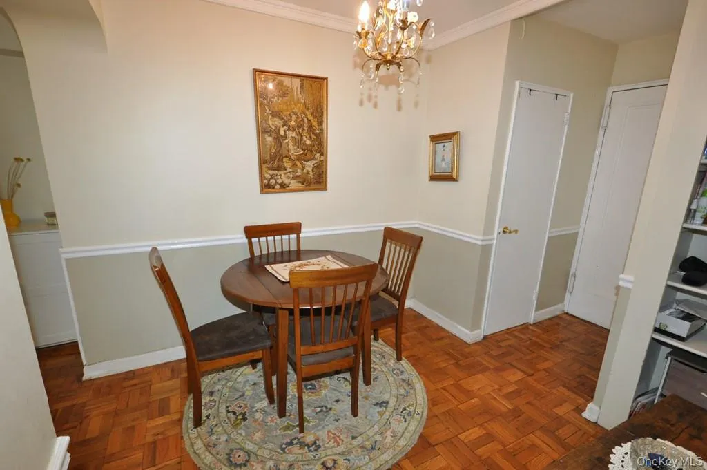 The dining foyer opens to the living room and has a chair rail and parquet floors. The dining foyer opens to the living room and has a chair rail and parquet floors.
