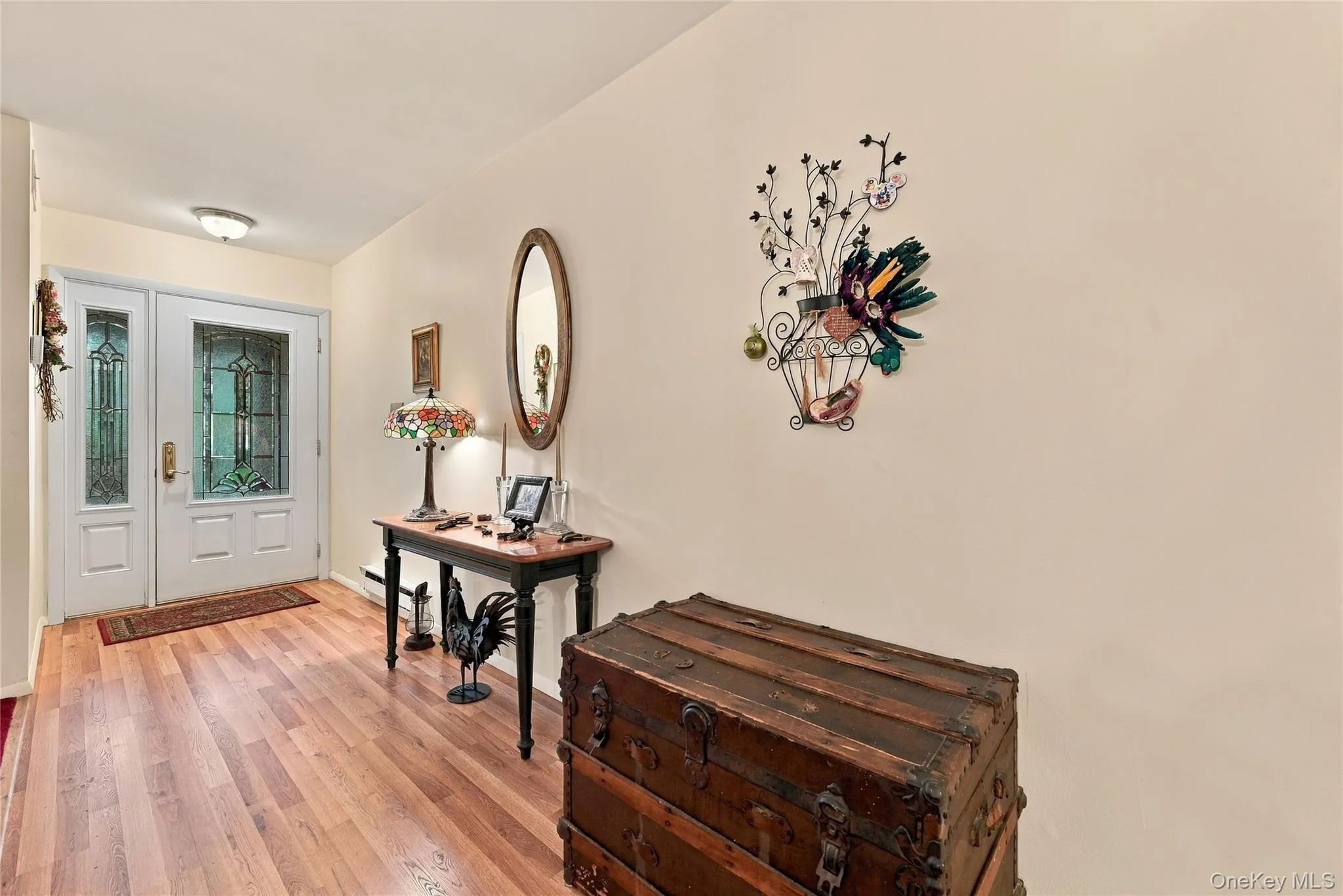 Entrance foyer area with Laminate wood flooring and beautiful door. Entrance foyer area with Laminate wood flooring and beautiful door.