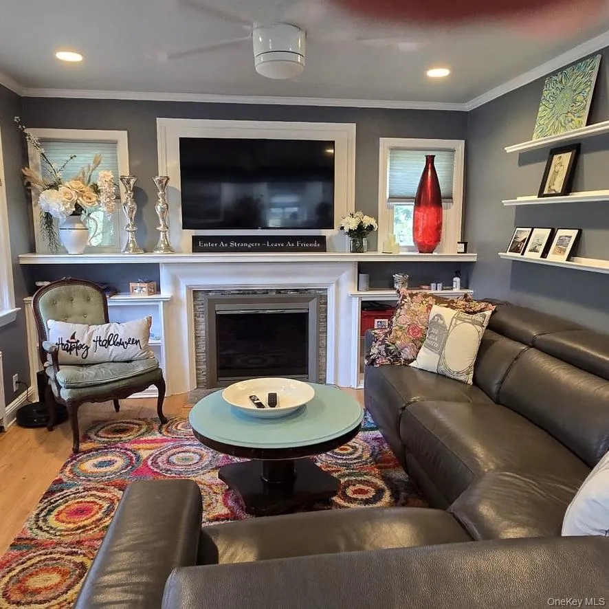 Recessed lighting illuminates the living space with wood-finish flooring Recessed lighting illuminates the living space with wood-finish flooring