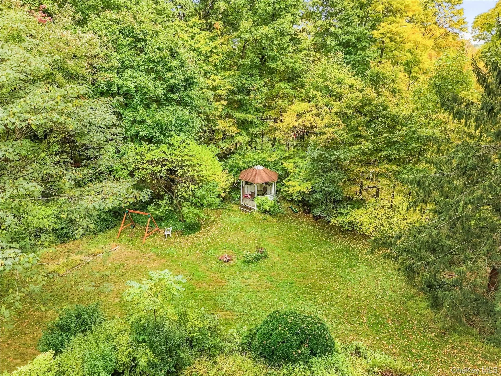 Rear yard is framed beautifully with the colors of Fall. Rear yard is framed beautifully with the colors of Fall.