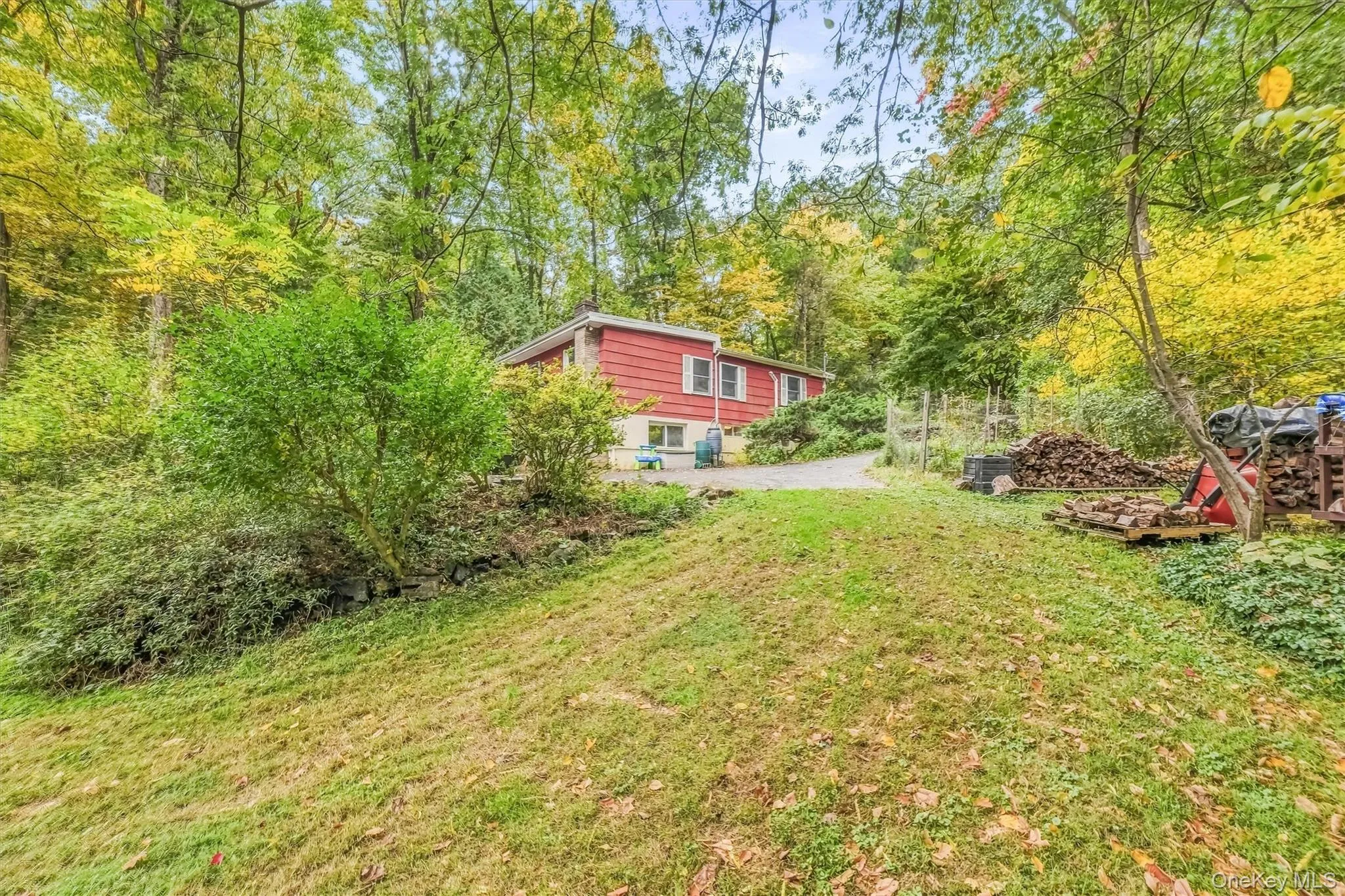 View of side of house from yard with garden. View of side of house from yard with garden.