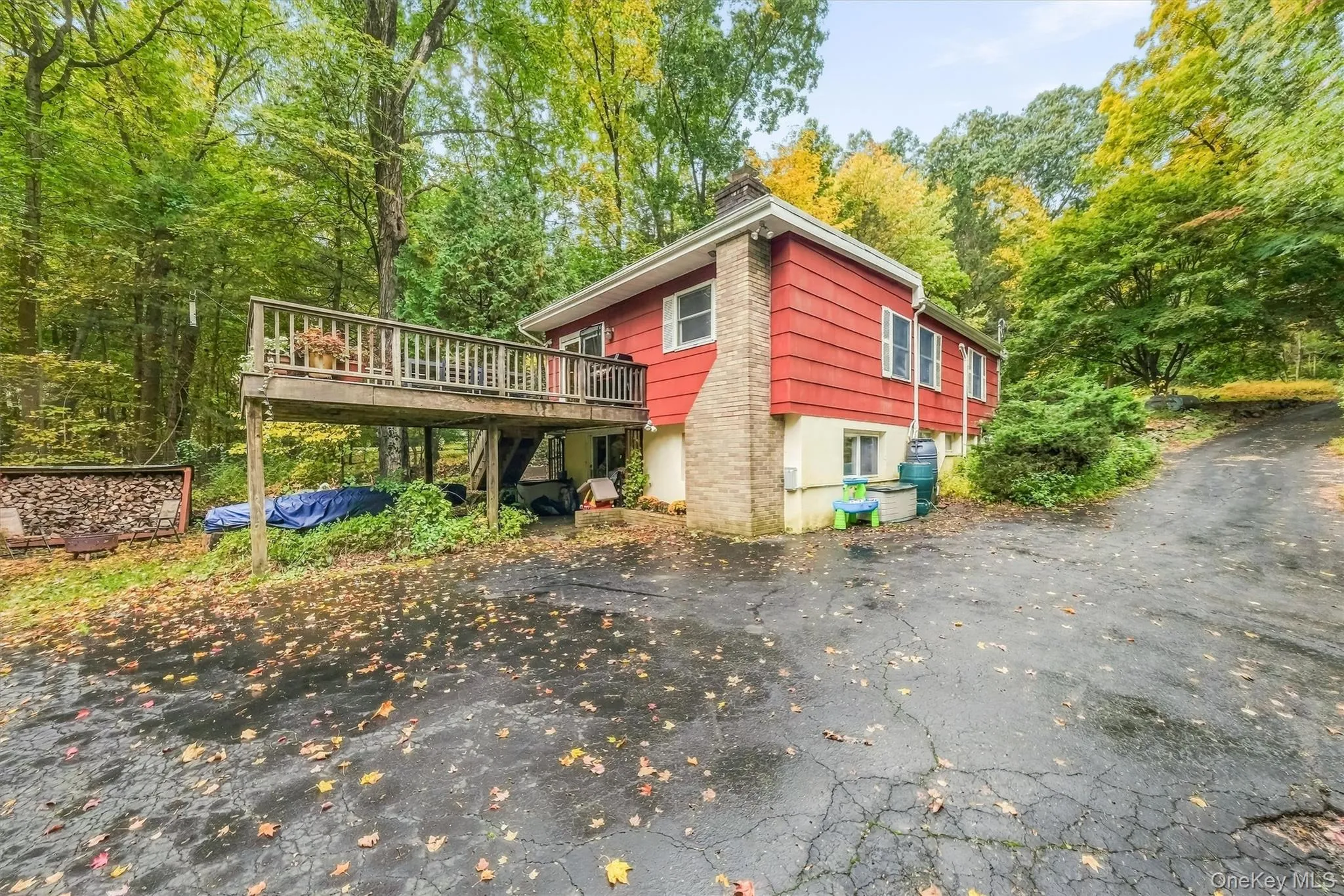 View of deck off kitchen and wide driveway for plenty of parking. View of deck off kitchen and wide driveway for plenty of parking.