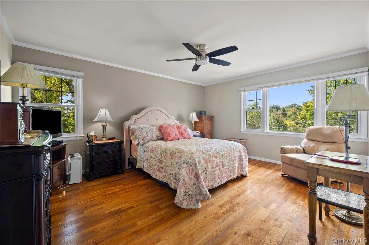 with oak floors and wall of windows with oak floors and wall of windows