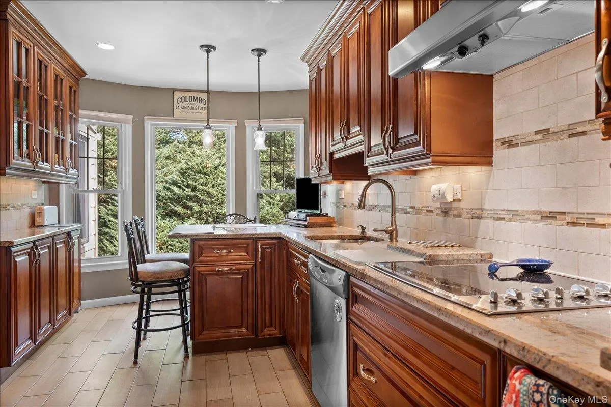 with eat in counter and view of yard with eat in counter and view of yard