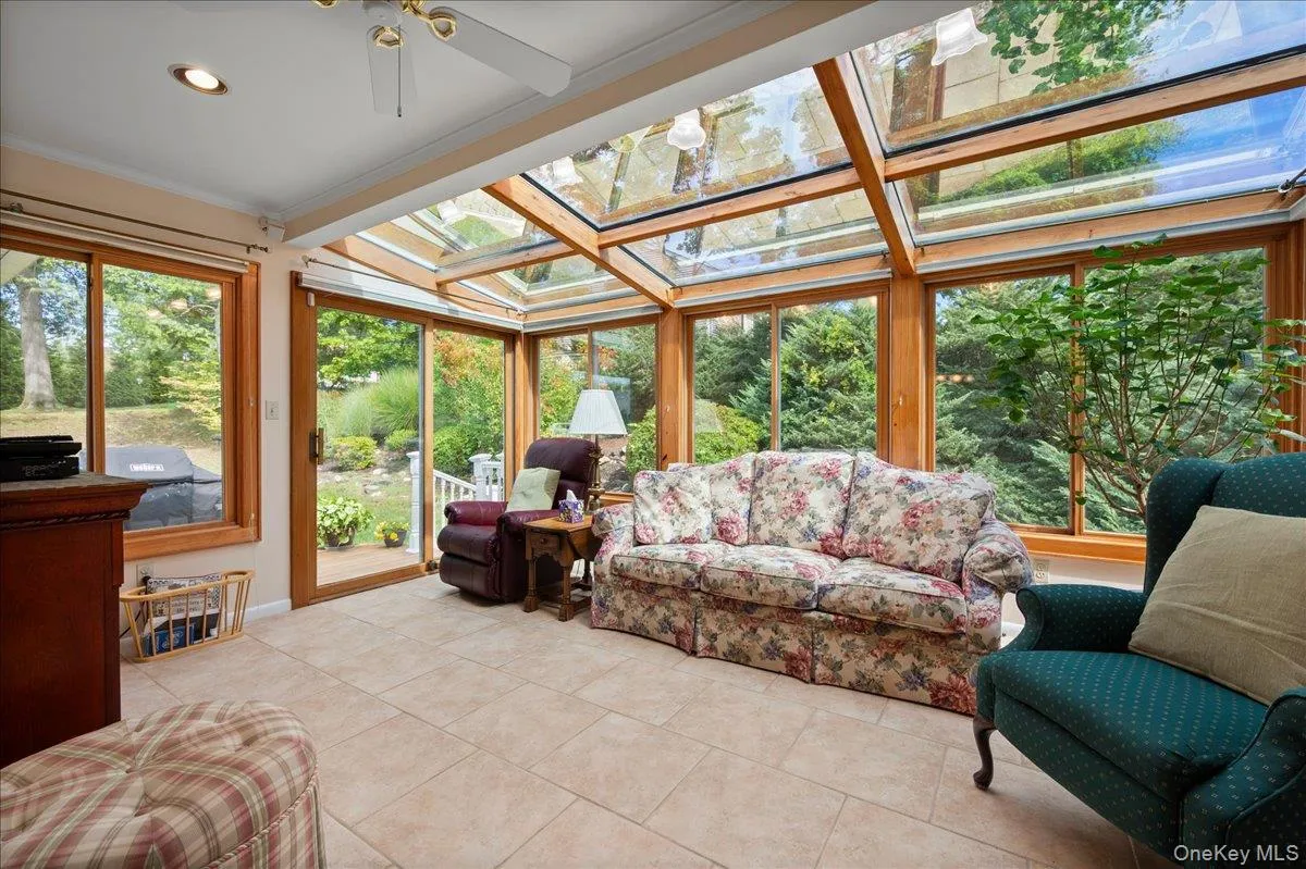 Four seasons room with slider to deck and windows that when open create a screened in porch feel Four seasons room with slider to deck and windows that when open create a screened in porch feel