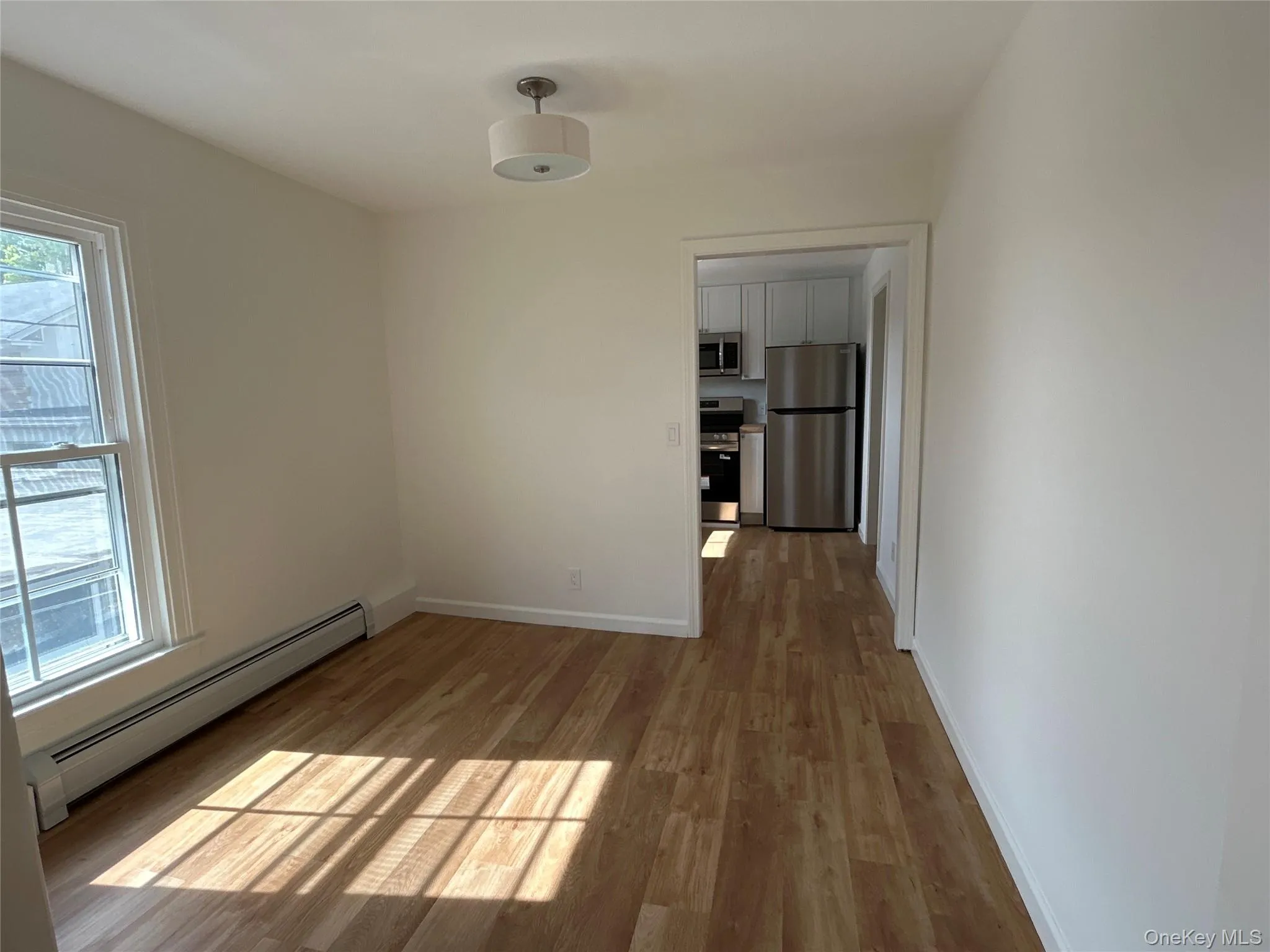 Bright dining room featuring laminate floors Bright dining room featuring laminate floors