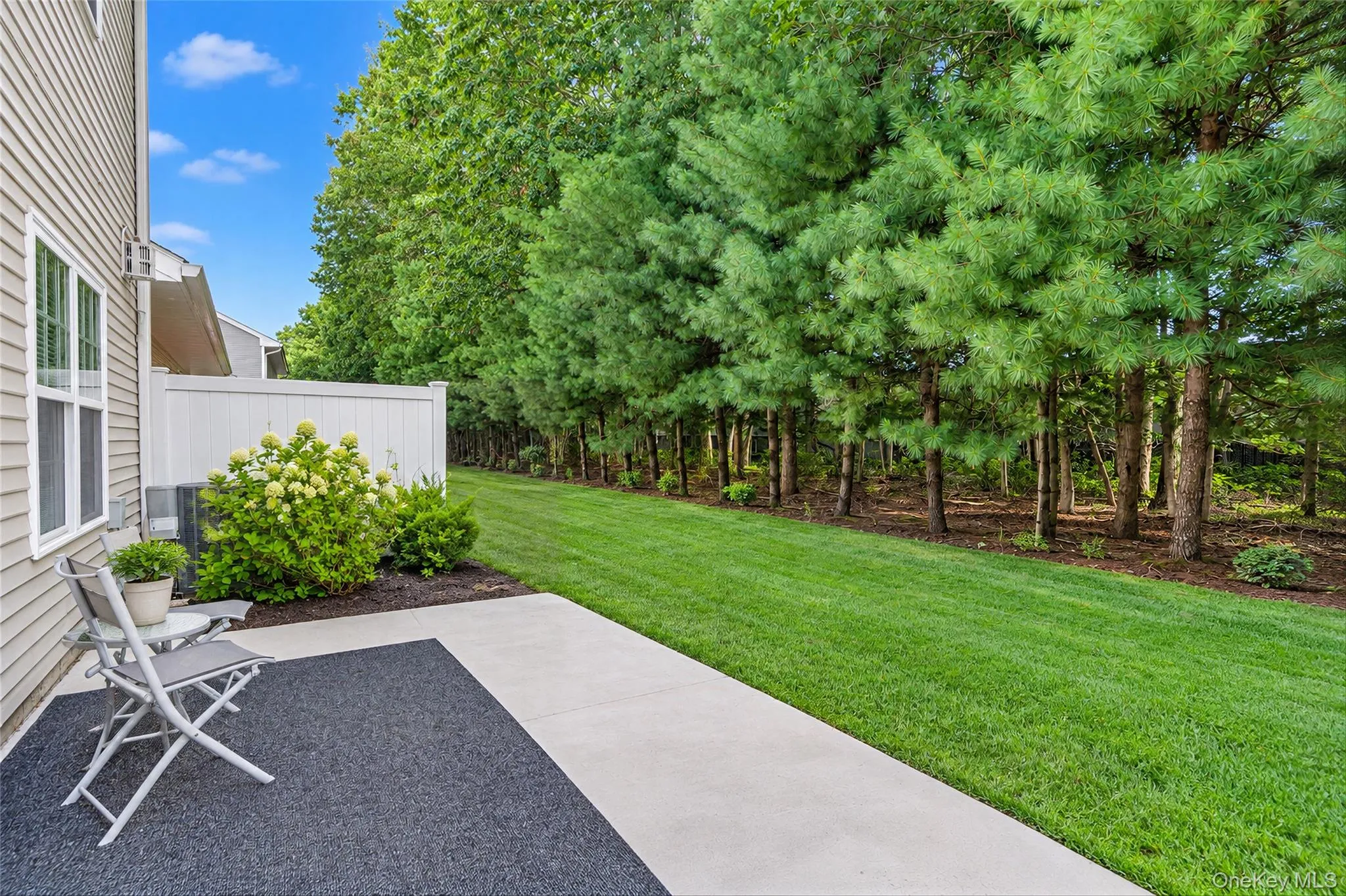 Private rear outdoor space bordered by mature landscaping Private rear outdoor space bordered by mature landscaping
