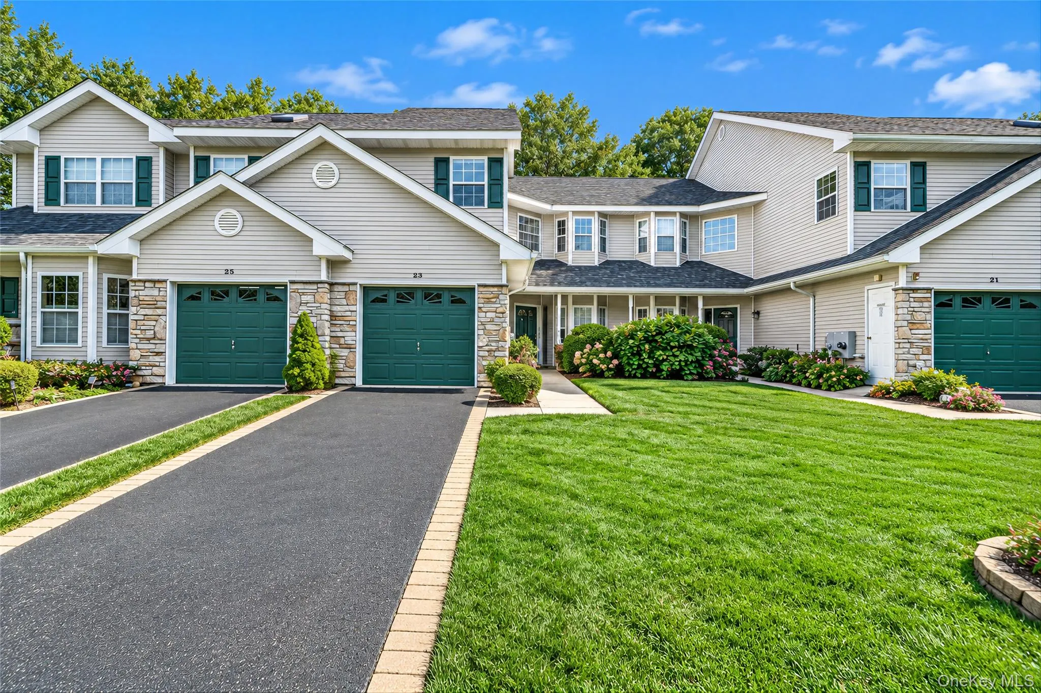 Front view with expansive driveway and attached garage Front view with expansive driveway and attached garage