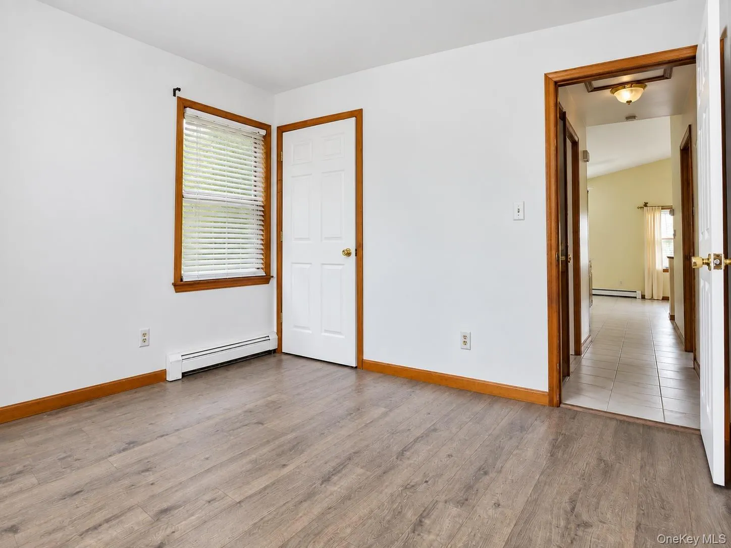 Wood-finish flooring, white walls, and natural wood trim accents Wood-finish flooring, white walls, and natural wood trim accents