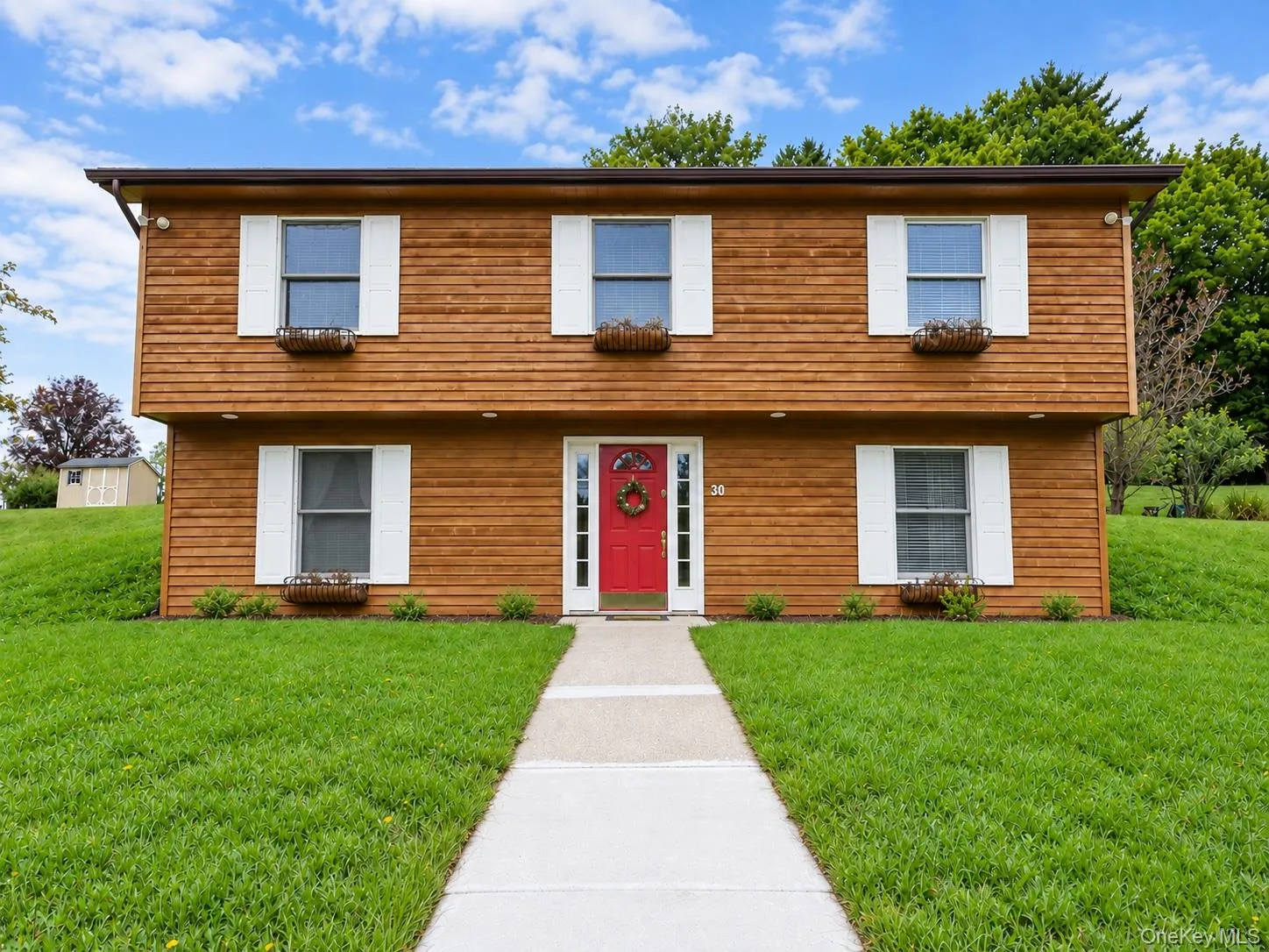 Wood-finish horizontal siding with white window shutters Wood-finish horizontal siding with white window shutters