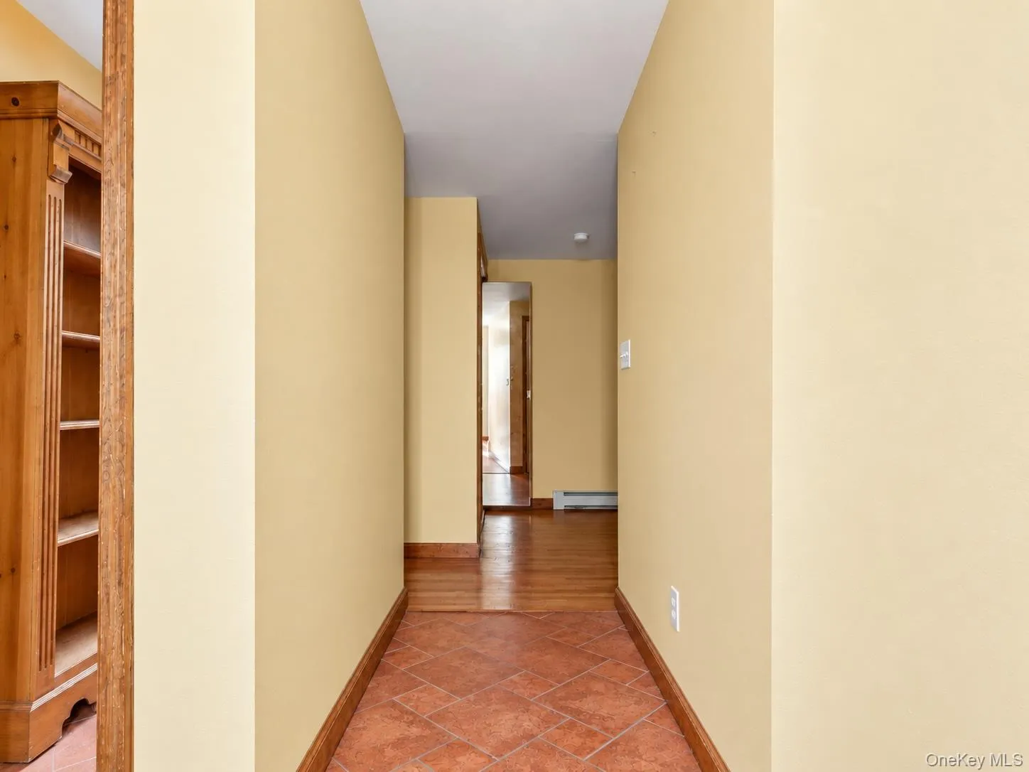 Tile flooring with wood-finish trim Tile flooring with wood-finish trim