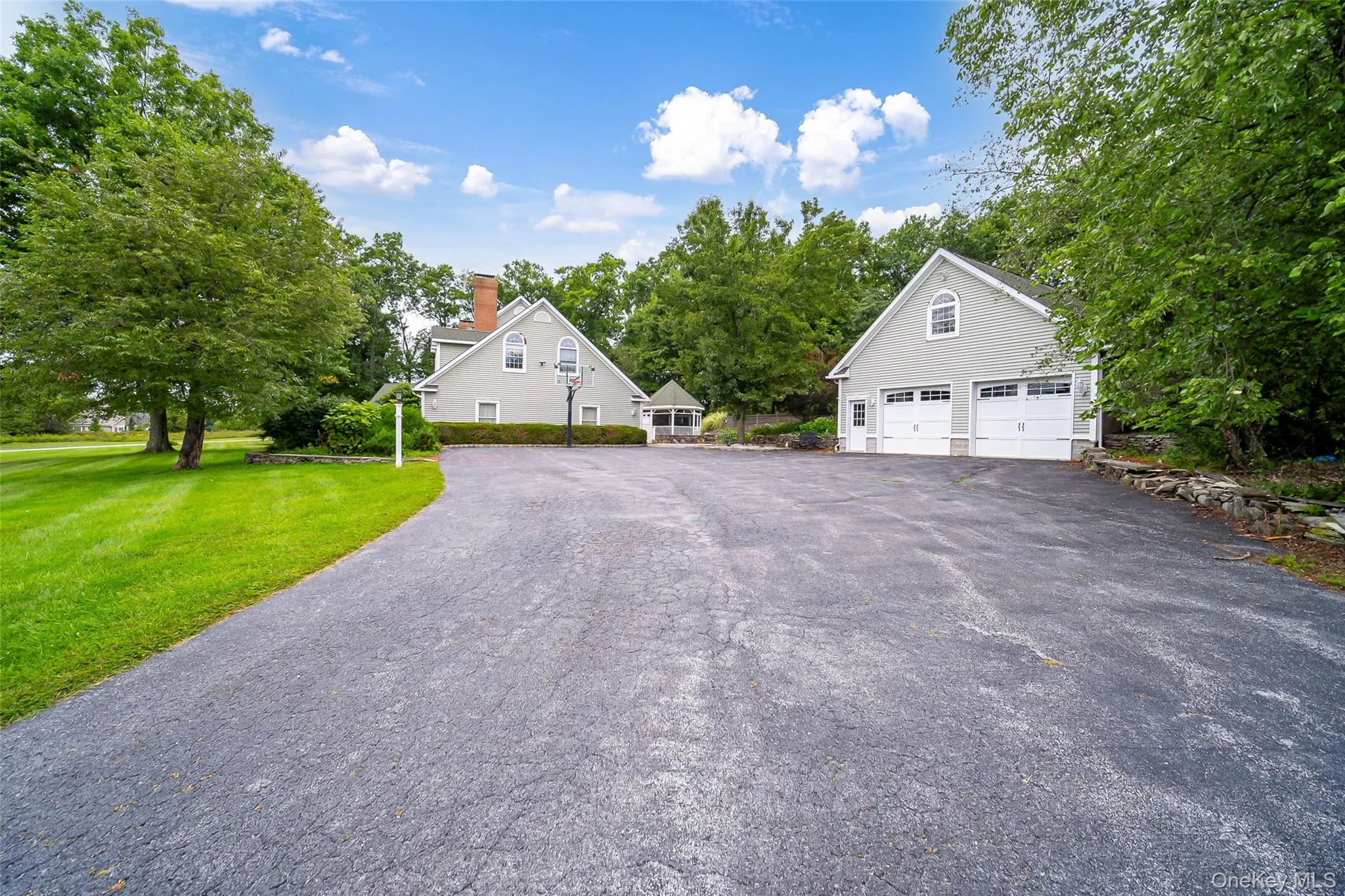 Expansive paved driveway with a separate detached two-car garage. Room for everyone! Expansive paved driveway with a separate detached two-car garage. Room for everyone!