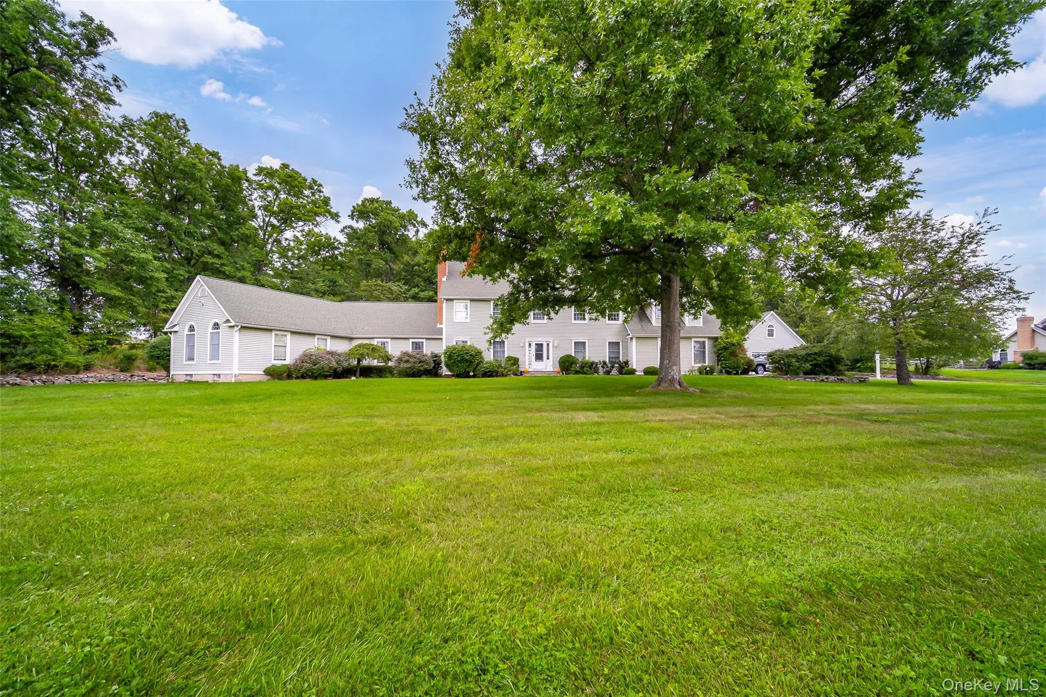 Expansive green lawn with mature trees. Expansive green lawn with mature trees.