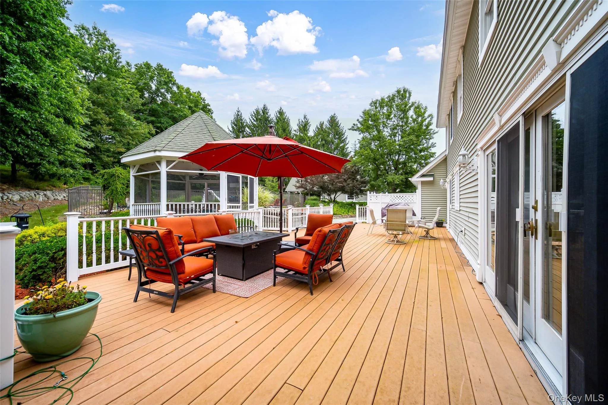 Expansive outdoor deck with a screened gazebo, and dual sliding glass doors to kitchen area. Expansive outdoor deck with a screened gazebo, and dual sliding glass doors to kitchen area.