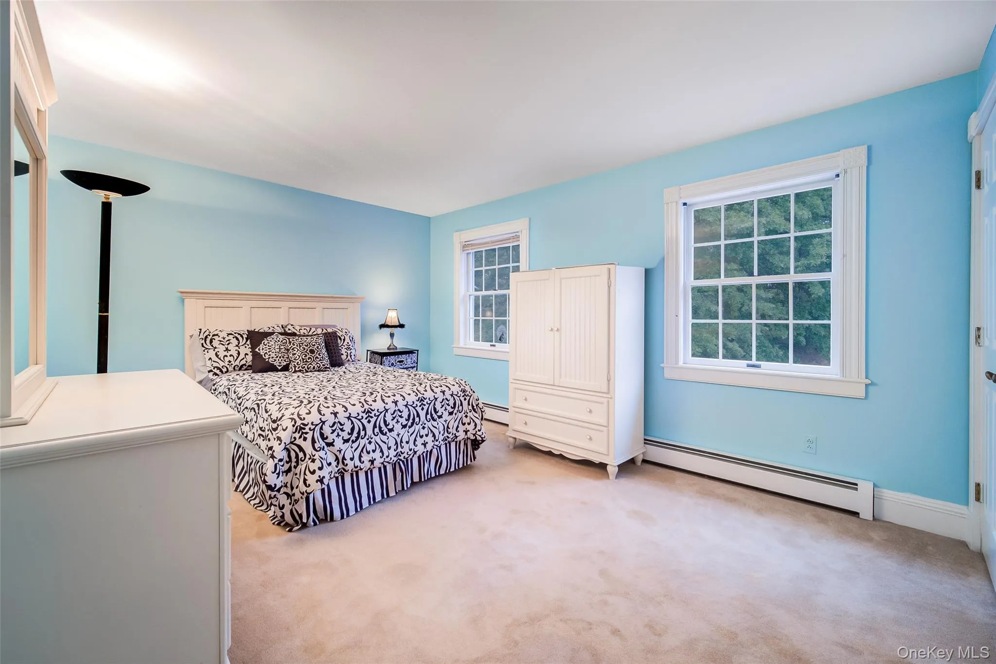 Bedroom #5 Is carpeted and features multiple windows and a large closet. Bedroom #5 Is carpeted and features multiple windows and a large closet.