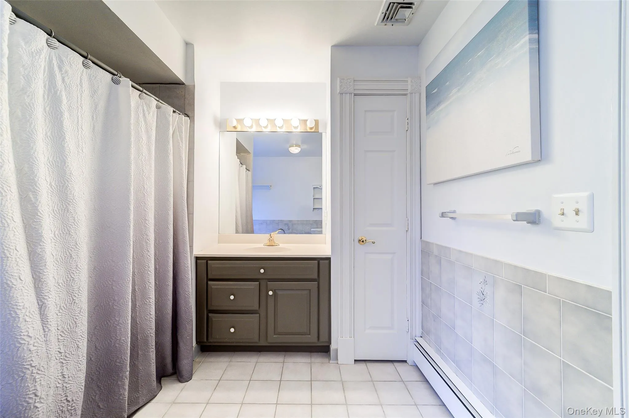 White tile flooring and a shower can be found in en-suite White tile flooring and a shower can be found in en-suite