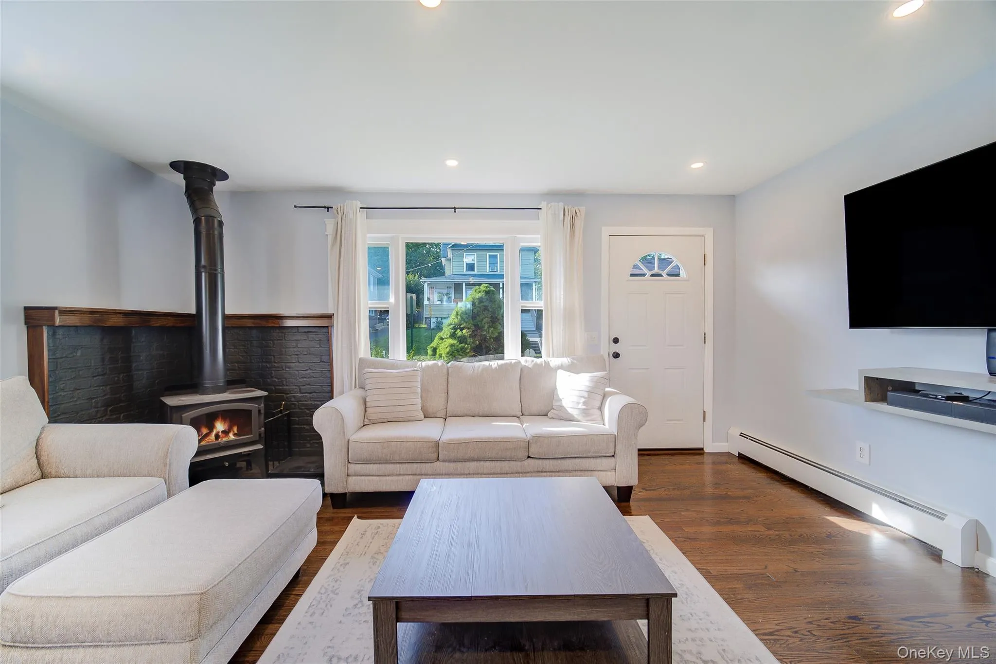 Hardwood flooring, recessed lighting, wood-burning stove with beautiful brick surround, Hardwood flooring, recessed lighting, wood-burning stove with beautiful brick surround,