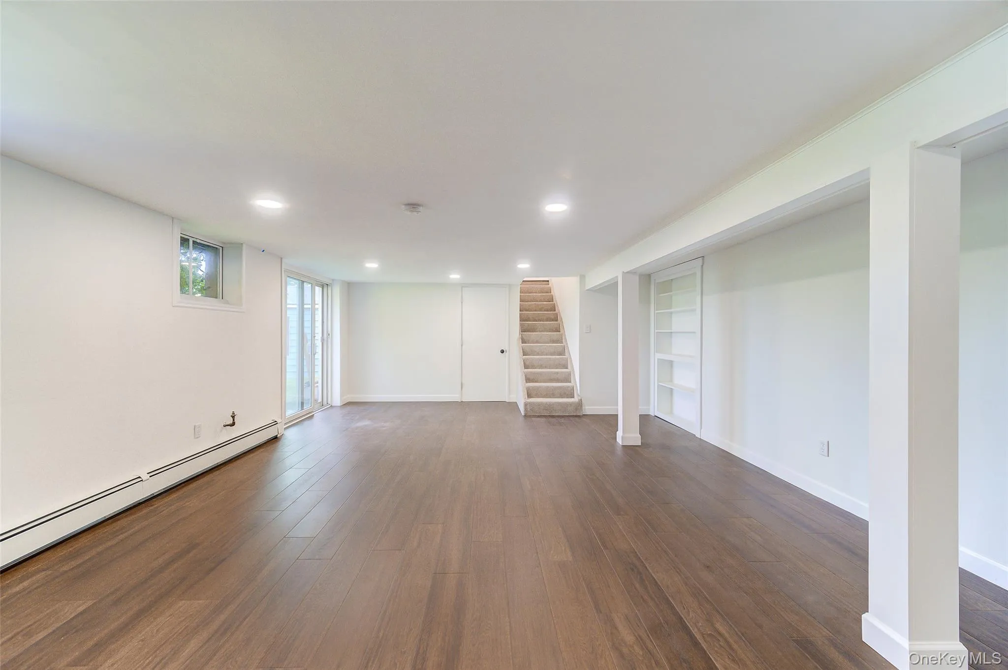 Expansive lower level with wood-finish flooring has walk out access to backyard Expansive lower level with wood-finish flooring has walk out access to backyard