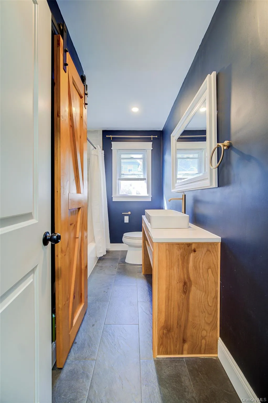 Full bath has custom made sliding barn door for linen storage, and vanity with stone top Full bath has custom made sliding barn door for linen storage, and vanity with stone top