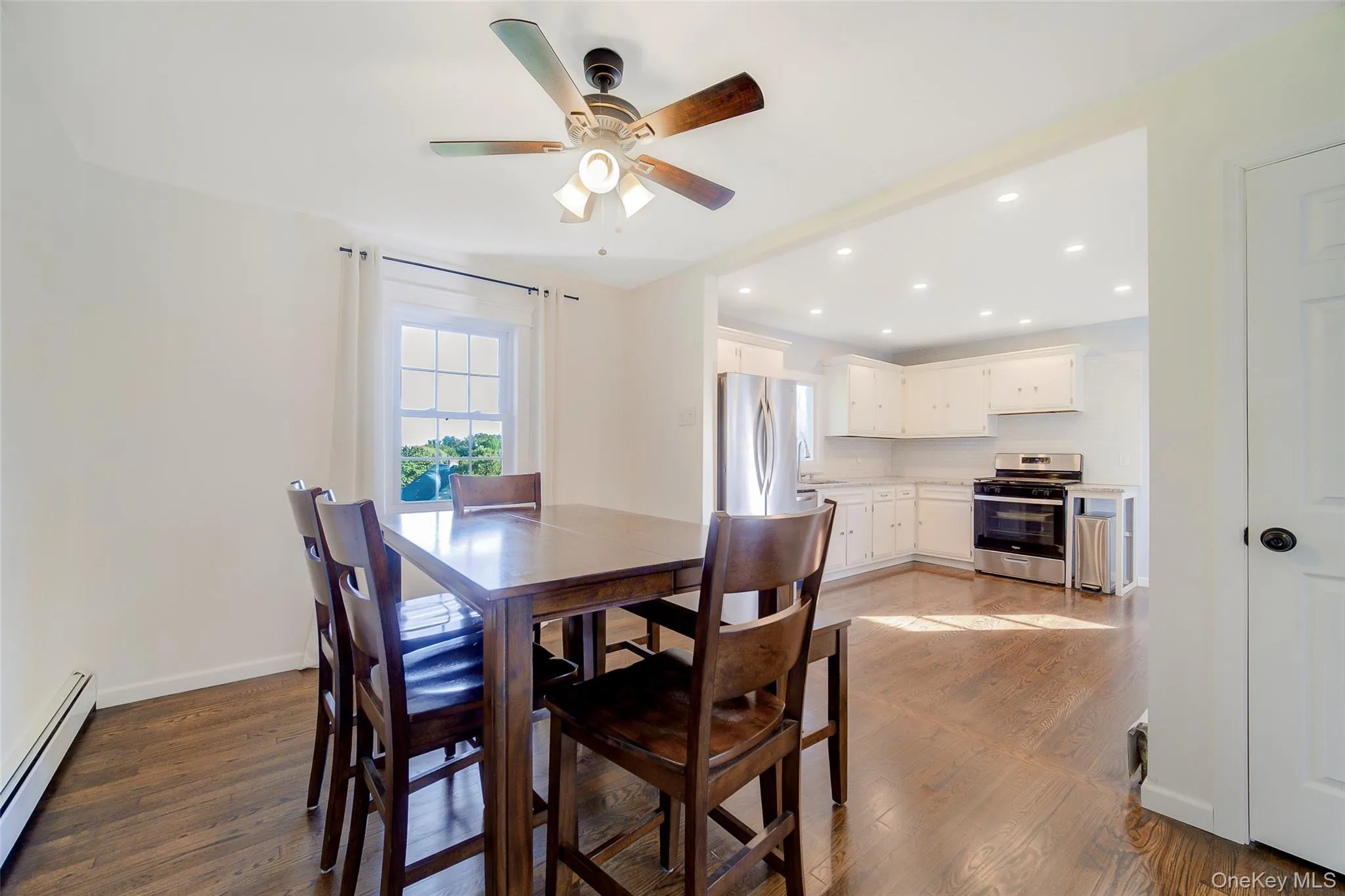 Open to kitchen with seamless hardwood flooring Open to kitchen with seamless hardwood flooring