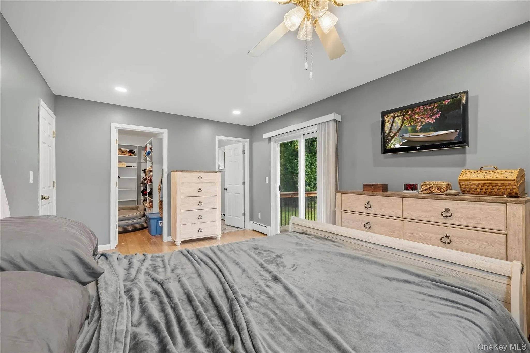 Recessed lighting, wood-finish flooring, walk-in closet, ceiling fan, and sliding glass door Recessed lighting, wood-finish flooring, walk-in closet, ceiling fan, and sliding glass door